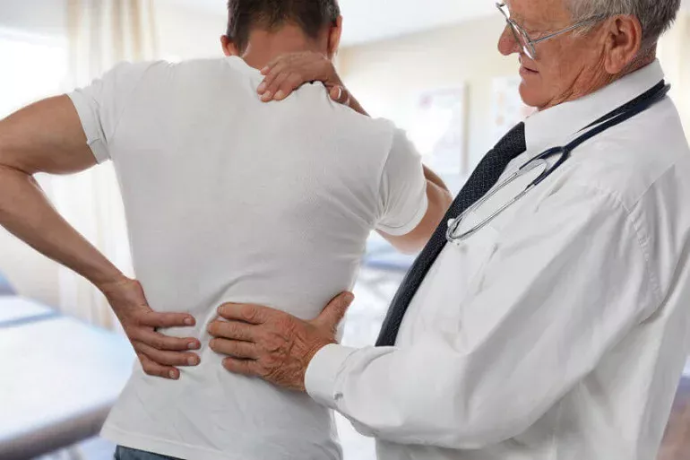 doctor-examining-back-injury-social